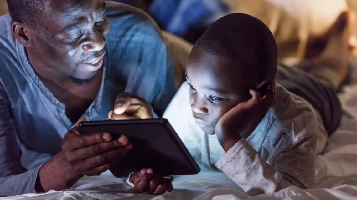Father is showing tablet to his child